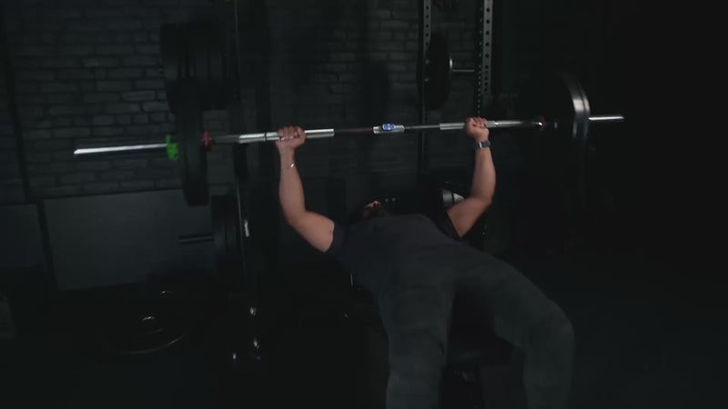 Man bench pressing with Calibrex and the Calibrex coach says he should take some weight off for the next set.